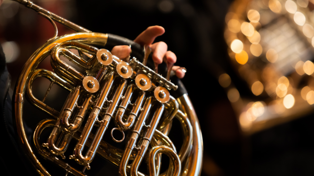 close up of a shiny brass instrument being played